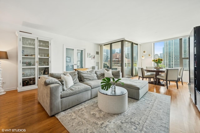 living room featuring wood-type flooring and expansive windows