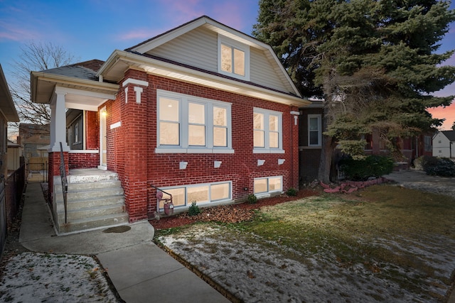 property exterior at dusk with a yard