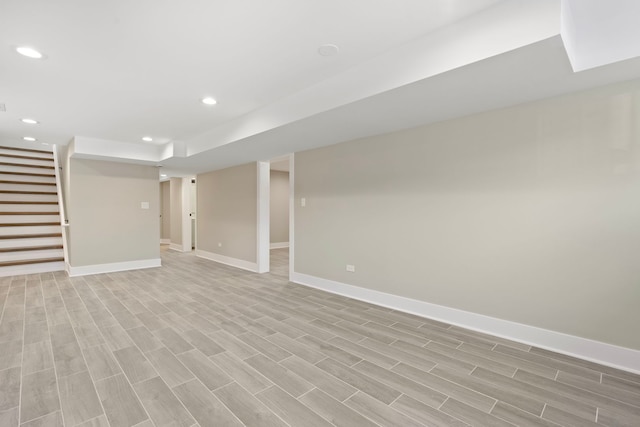 basement with light hardwood / wood-style flooring