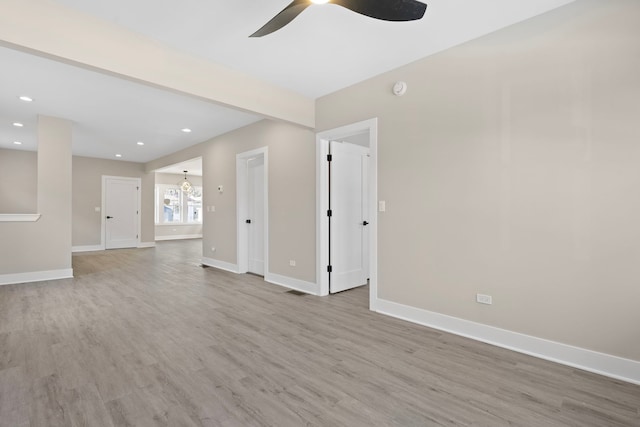 unfurnished room featuring ceiling fan and light wood-type flooring