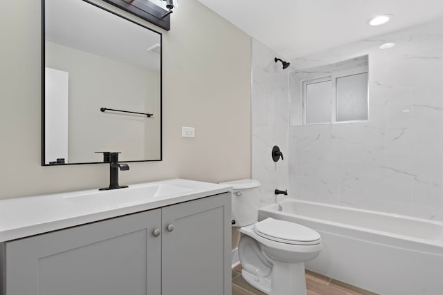 full bathroom featuring vanity, toilet, and tiled shower / bath