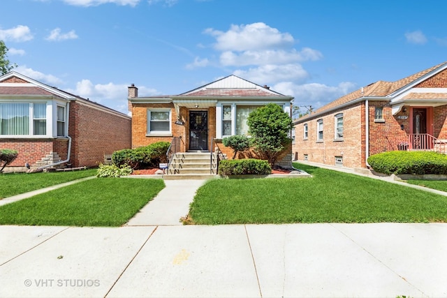 bungalow-style home with a front lawn