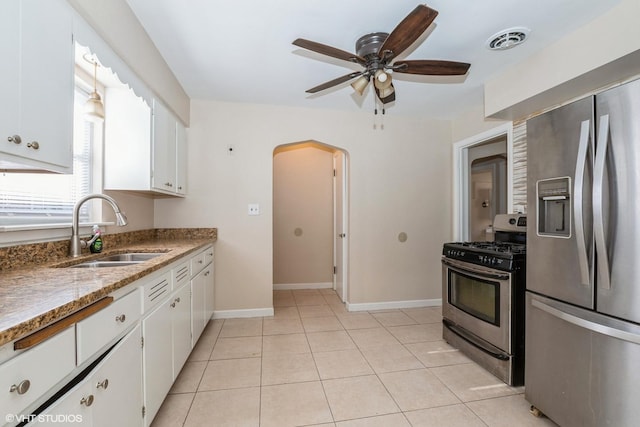 kitchen featuring white cabinets, sink, ceiling fan, light tile patterned floors, and stainless steel appliances