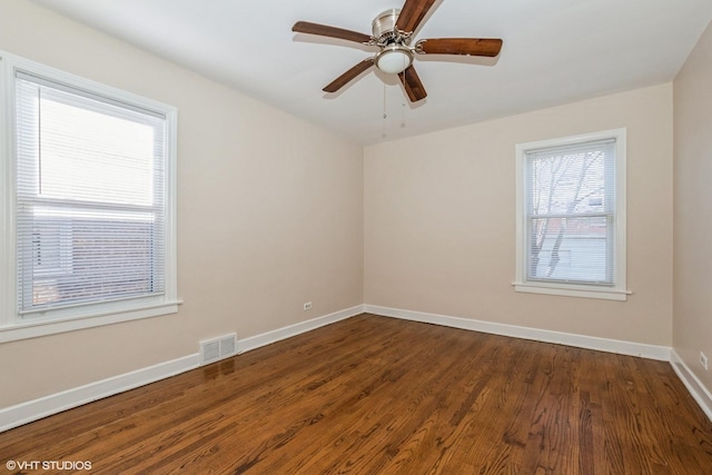 spare room featuring ceiling fan and dark wood-type flooring