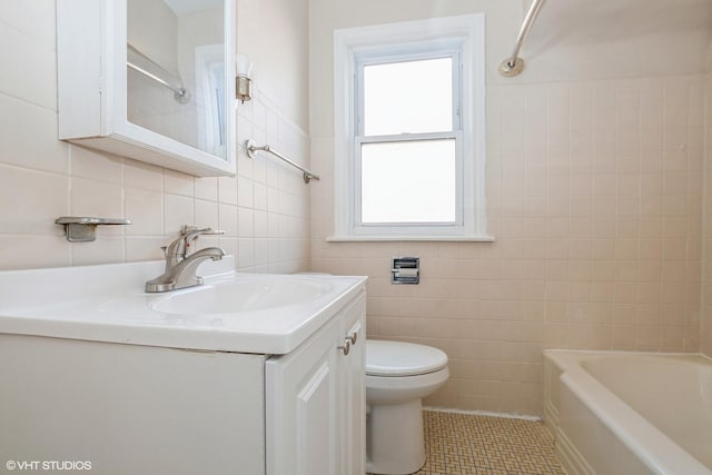 full bathroom with tile patterned floors, vanity, toilet, and tile walls