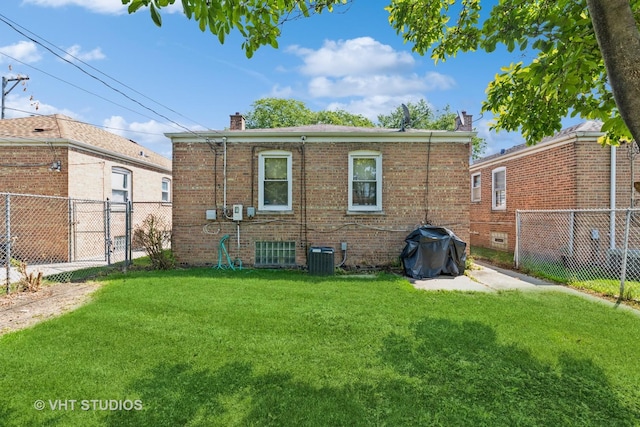 rear view of property with a yard