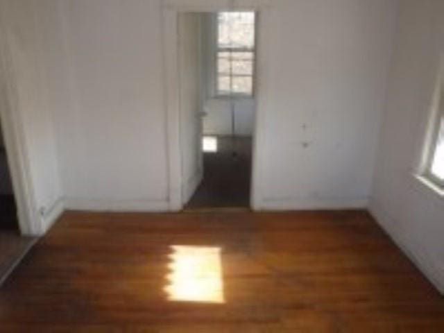 empty room featuring dark hardwood / wood-style flooring