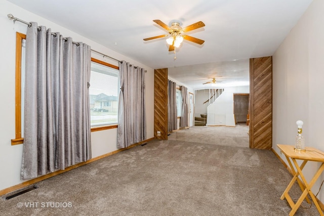 empty room with ceiling fan and light colored carpet