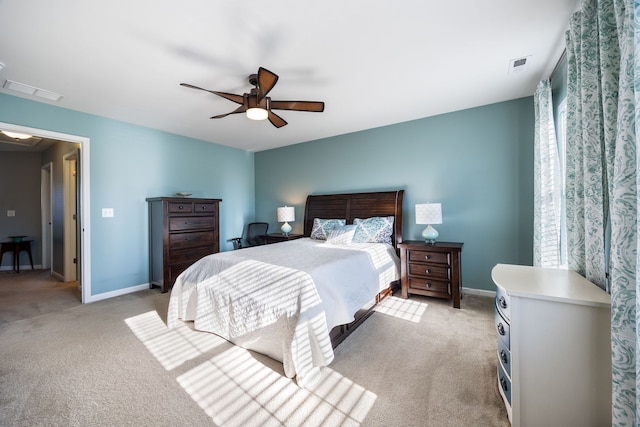 bedroom with ceiling fan and light carpet