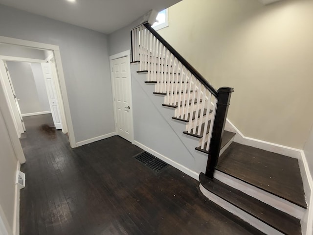 staircase with hardwood / wood-style flooring