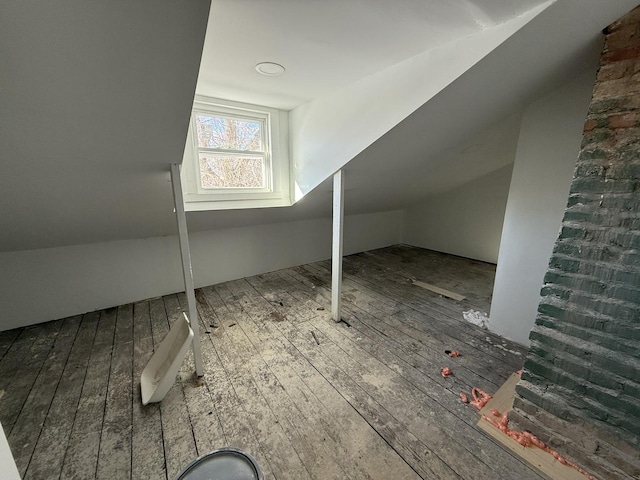 additional living space featuring wood-type flooring and lofted ceiling