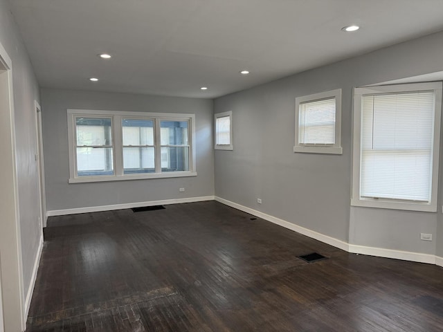 unfurnished room featuring dark hardwood / wood-style flooring