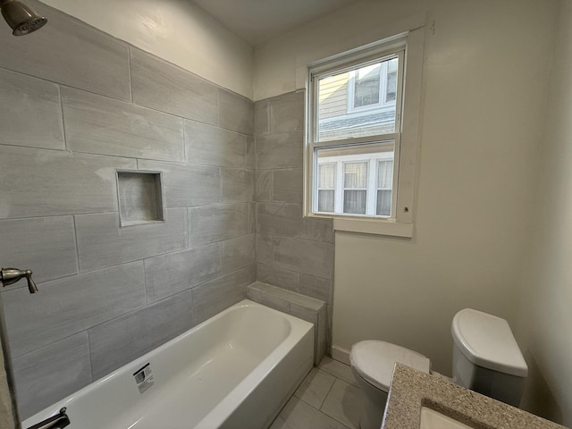 bathroom featuring tile patterned floors, tiled shower / bath combo, and toilet