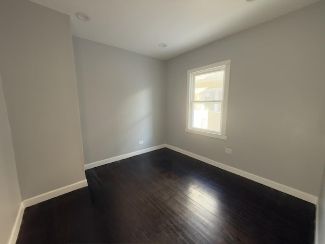 unfurnished room with dark hardwood / wood-style floors