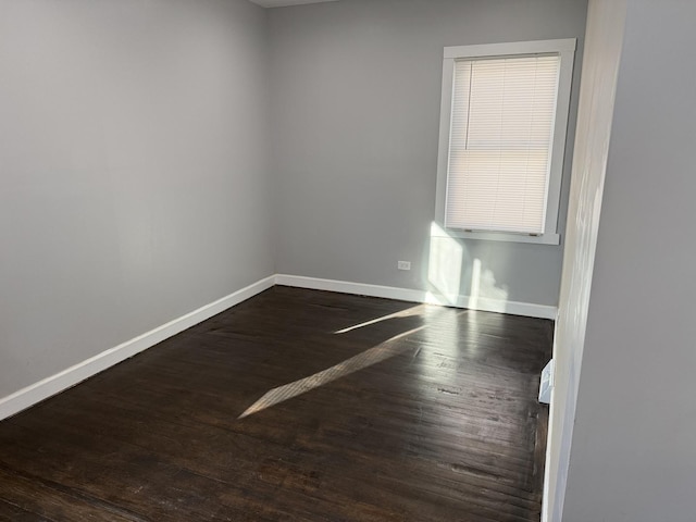 spare room with dark hardwood / wood-style flooring