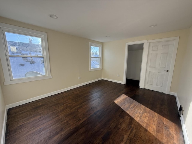 unfurnished bedroom featuring dark wood-type flooring