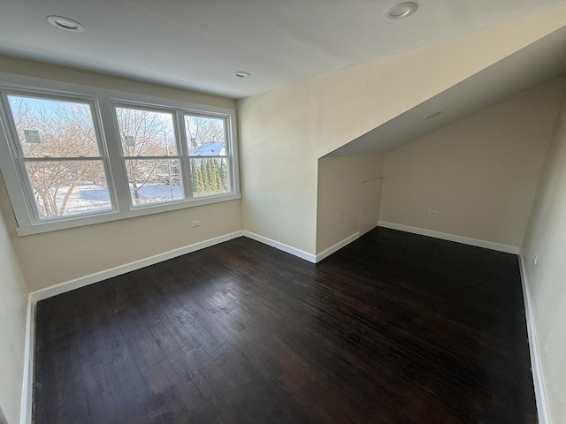 additional living space featuring dark wood-type flooring