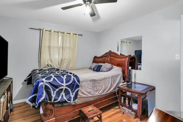 bedroom with hardwood / wood-style flooring and ceiling fan