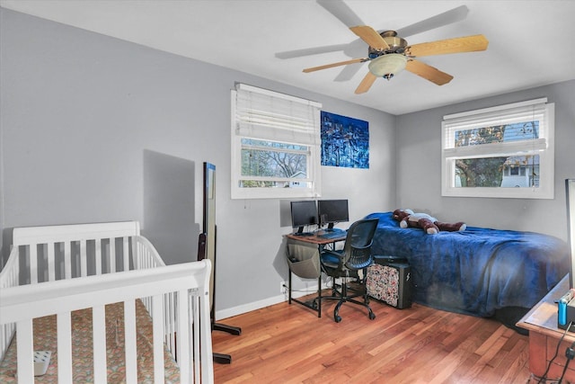 bedroom with ceiling fan and hardwood / wood-style flooring