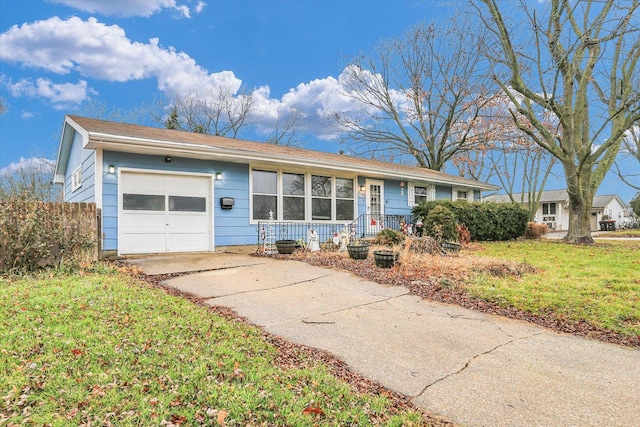 ranch-style house featuring a garage and a front lawn