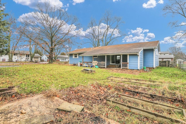 back of house featuring a lawn