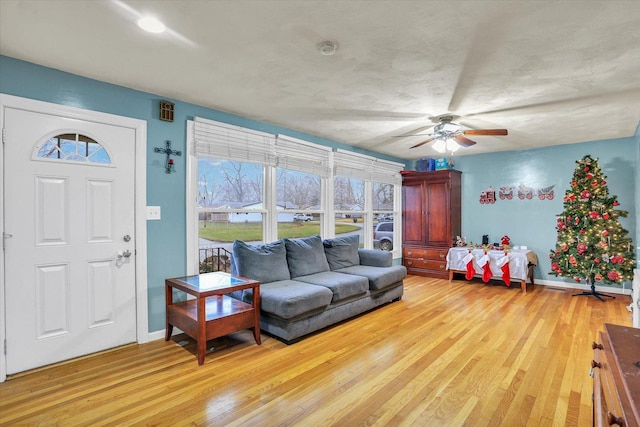 living room featuring light wood-type flooring and ceiling fan