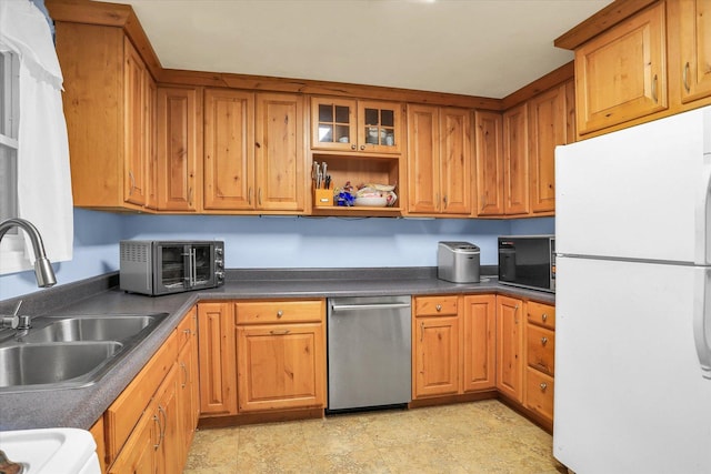 kitchen with dishwasher, white refrigerator, and sink