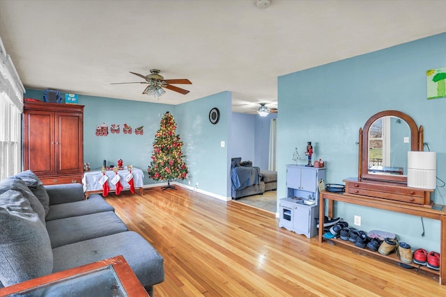 living room with light hardwood / wood-style floors and ceiling fan