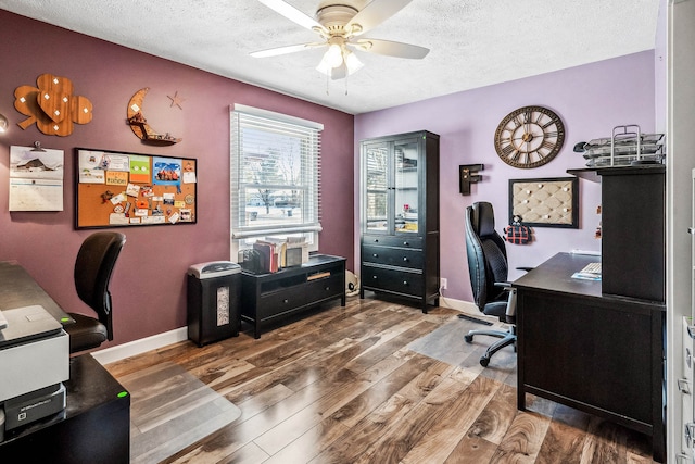 office space featuring a textured ceiling, ceiling fan, and hardwood / wood-style flooring