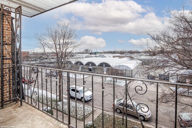 view of snow covered back of property