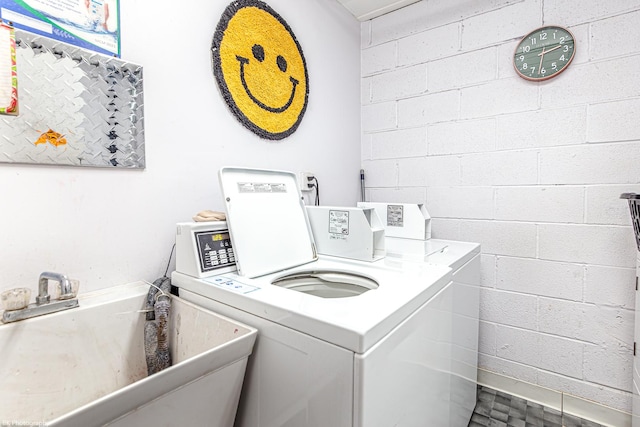 washroom with separate washer and dryer and sink