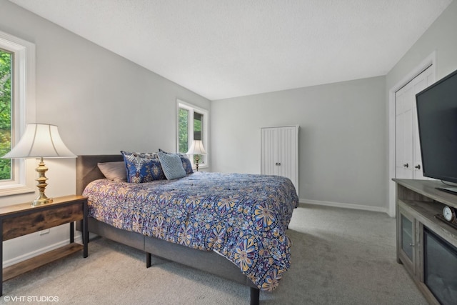 bedroom featuring carpet flooring and a textured ceiling