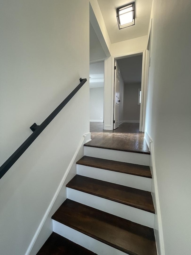 staircase featuring wood-type flooring