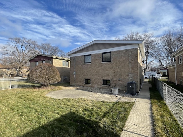 back of house featuring a yard, a patio, and central air condition unit