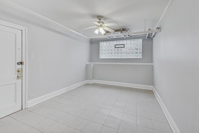 spare room featuring light tile patterned floors, ceiling fan, and ornamental molding