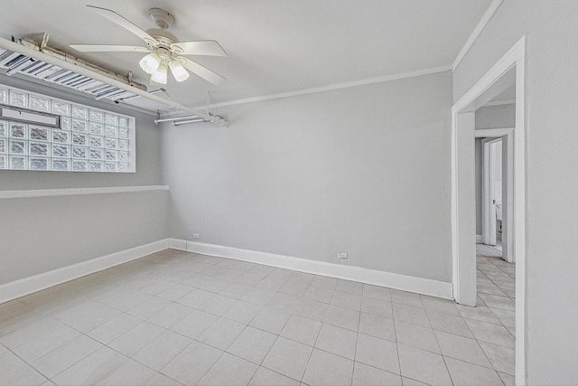 tiled spare room featuring ceiling fan and crown molding