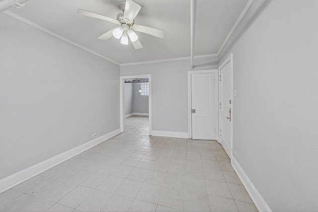 empty room featuring ceiling fan, light tile patterned floors, and crown molding