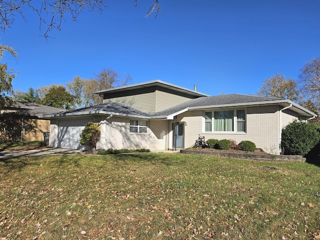 view of front of property with a garage and a front yard