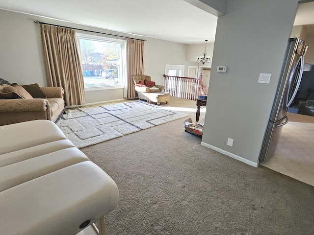 carpeted living room with a chandelier