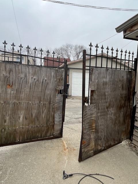 view of gate with an outbuilding