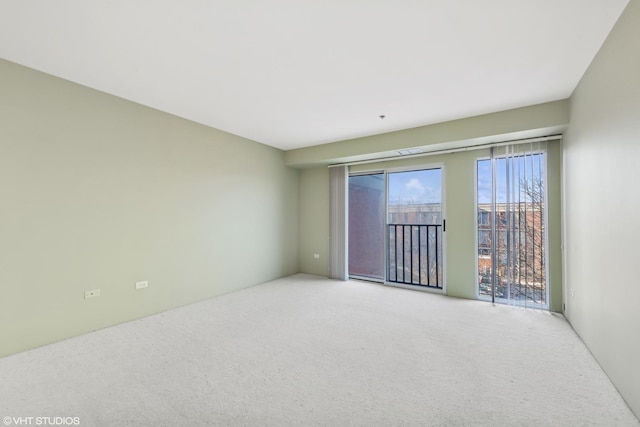 unfurnished room featuring light colored carpet