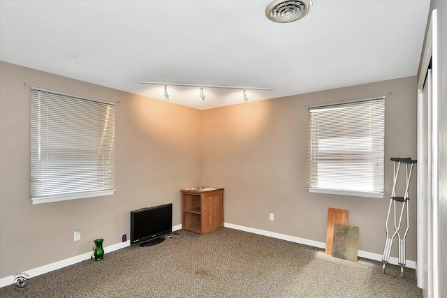 spare room with carpet flooring and track lighting