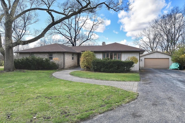 ranch-style house featuring a front yard, an outbuilding, and a garage