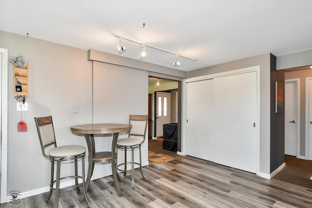 dining room with wood-type flooring