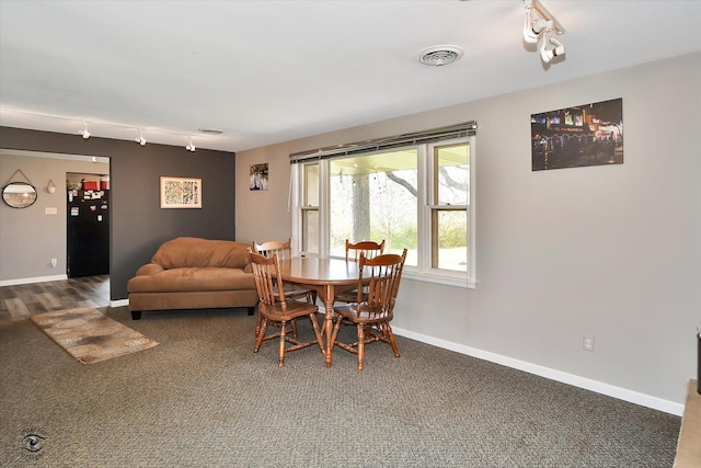 dining area with dark carpet