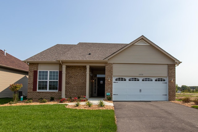 ranch-style home with a garage and a front lawn