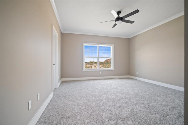 carpeted empty room featuring ornamental molding, ceiling fan, and baseboards