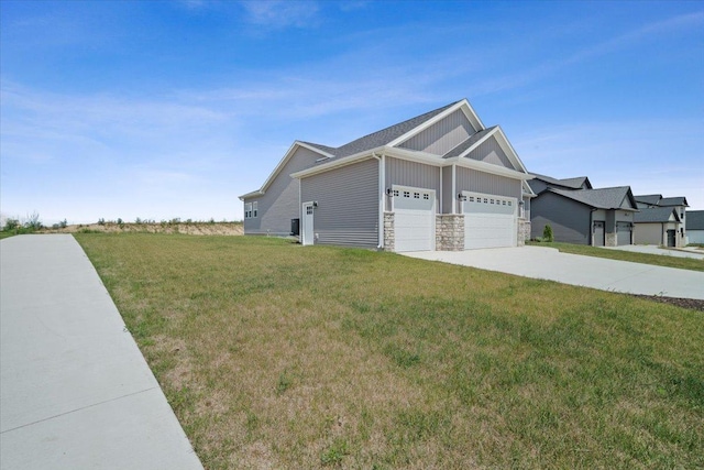 view of side of property with driveway, board and batten siding, an attached garage, and a lawn