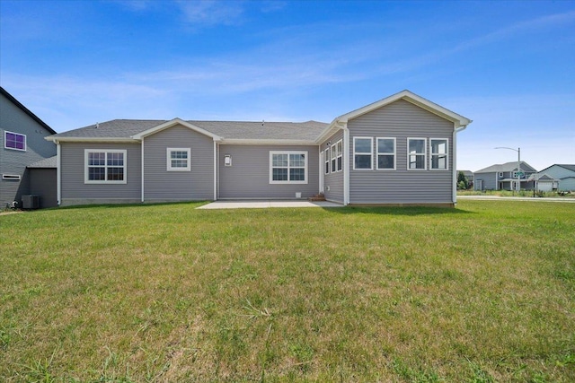 back of property featuring cooling unit, a patio, and a lawn