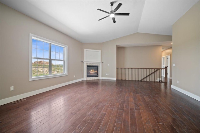 unfurnished living room featuring baseboards, visible vents, and dark wood finished floors